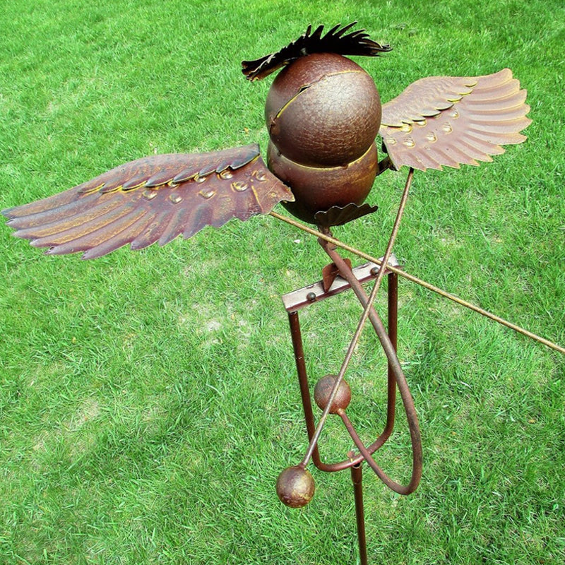 Hanging garden art wind spinner featuring metal bird