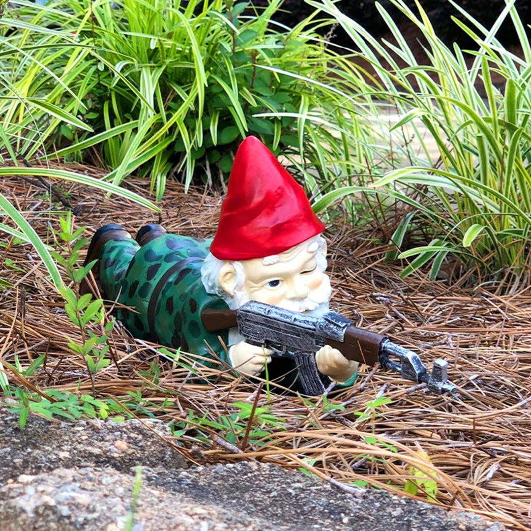 Lying down tactical garden gnome soldier figurine in grass
