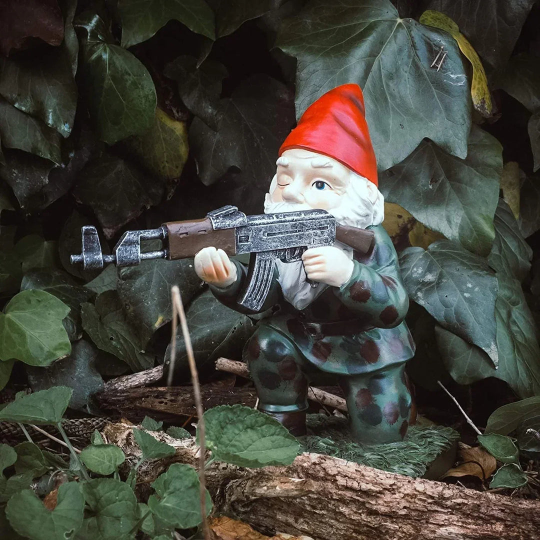 Kneeling military garden gnome statue with rifle outdoors