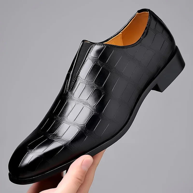 Top down view of formal men's black slip on shoes with sleek leather texture.