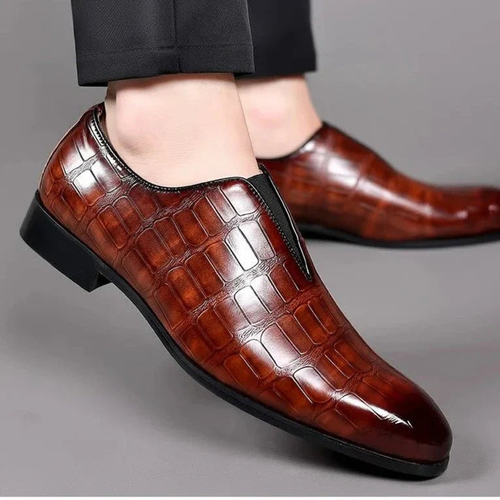 Men's brown dress loafers worn on foot showcasing style
