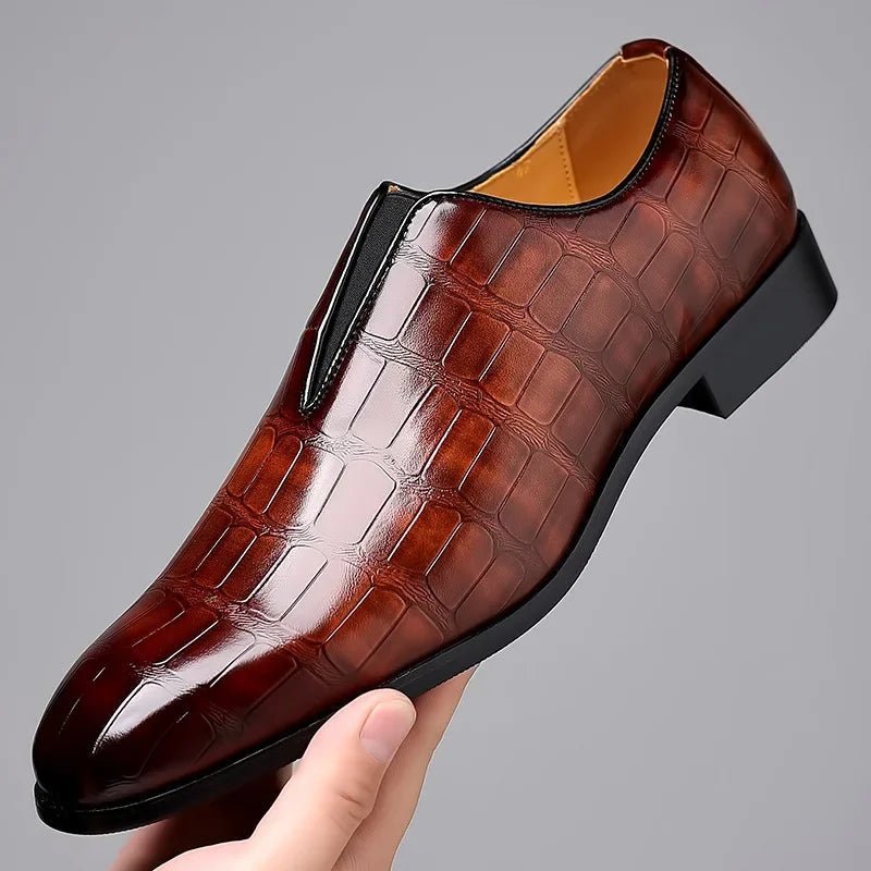 Men's brown lustrous finish dress loafer held in hand