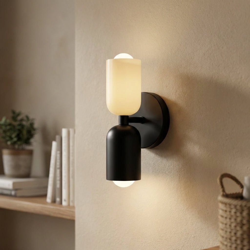 Illuminated modern wall sconce mounted on a neutral wall next to books