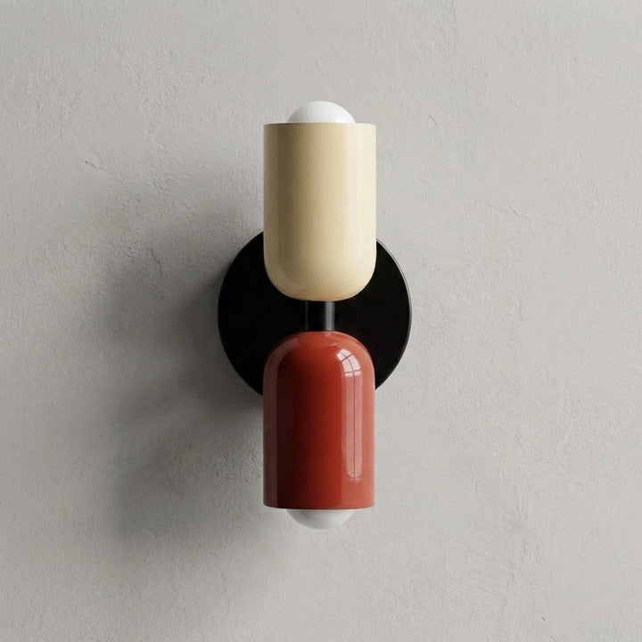 Modern geometric wall lamp with black mount and cream and red frosted glass shades
