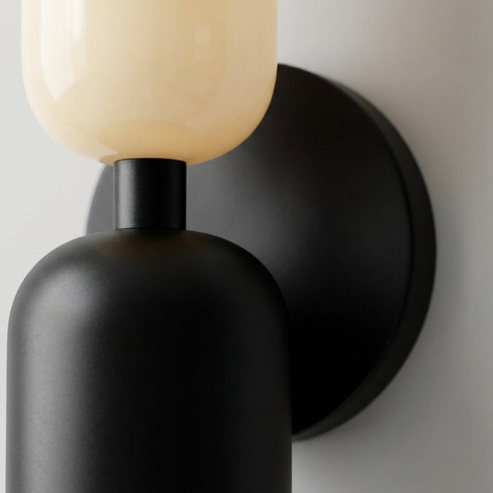 Modern geometric wall lamp glowing softly, perfect for ambient home lighting and interior decor.