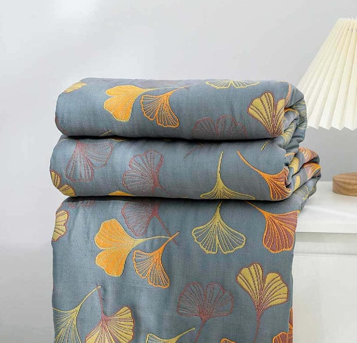 Folded ginkgo leaf throw blanket showing blue and yellow pattern