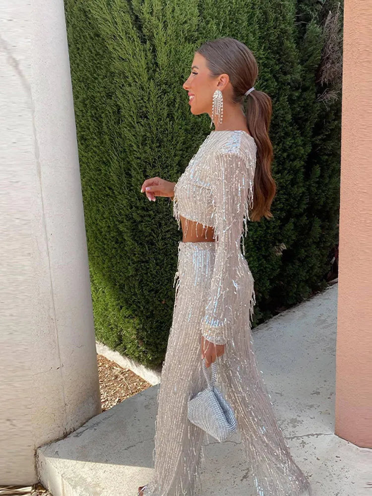 Side profile of a woman showcasing the sparkling sequin top and trousers set