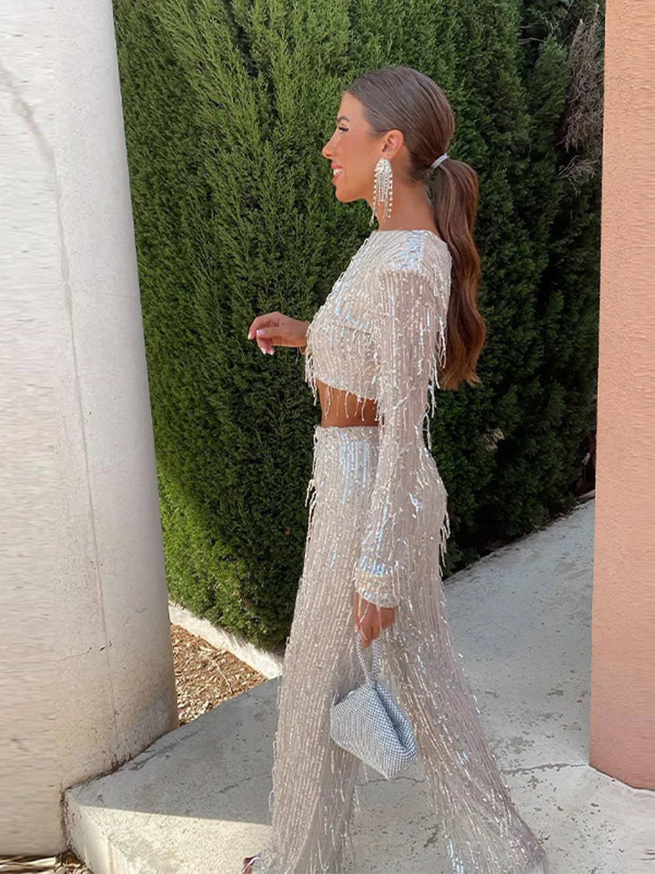 Side profile of a woman showcasing the sparkling sequin top and trousers set