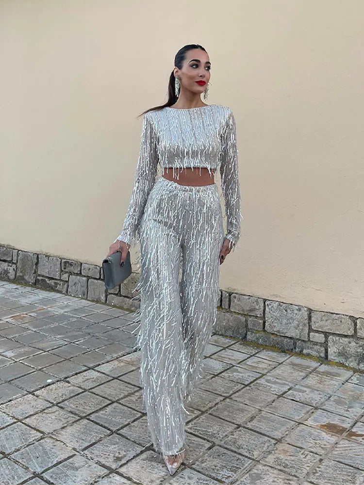 Womens black sequin two piece party outfit featuring crop top and high waist trousers