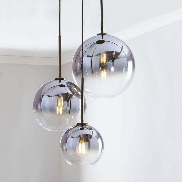 Contemporary glass pendant lamp showcasing gradient silver spherical shades and dark metal hardware
