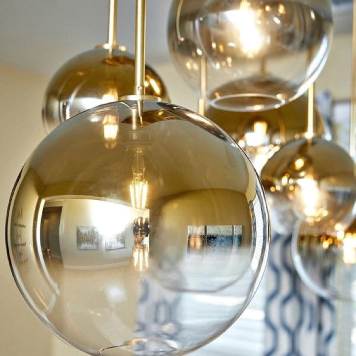 Modern glass ball pendant light viewed from a low angle against a neutral ceiling