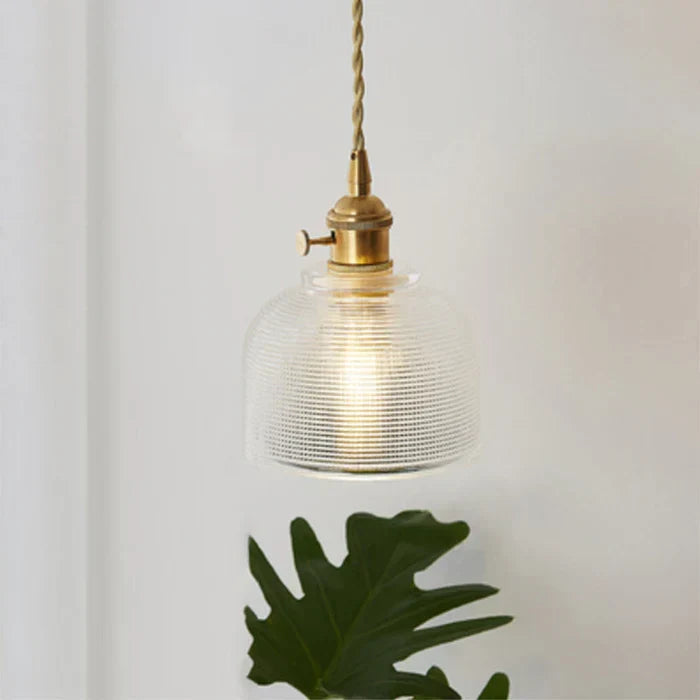 Hanging lamp with clear glass design casting ambient light across the ceiling
