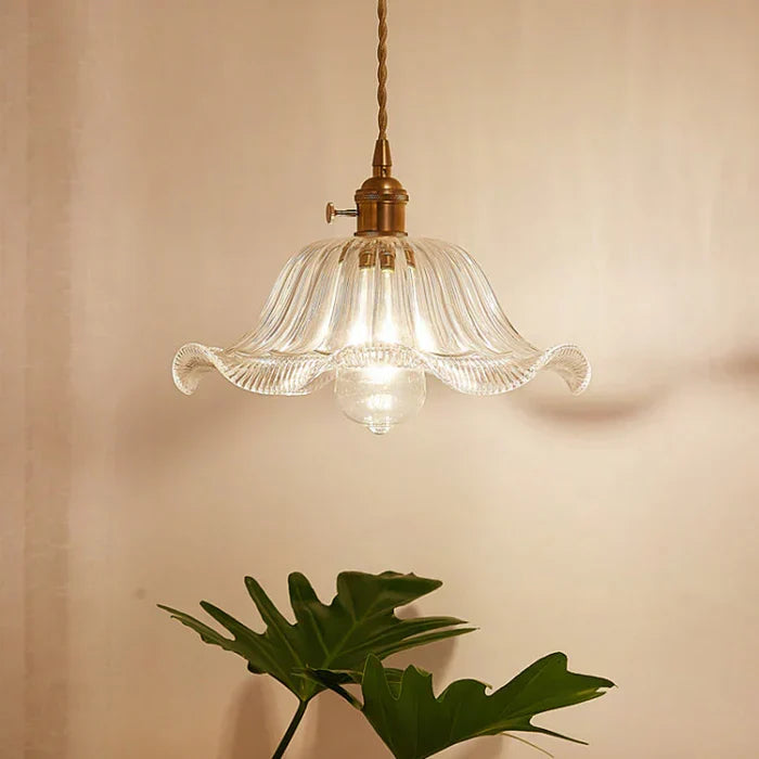 Clear glass fixture casting geometric light patterns on surrounding walls
