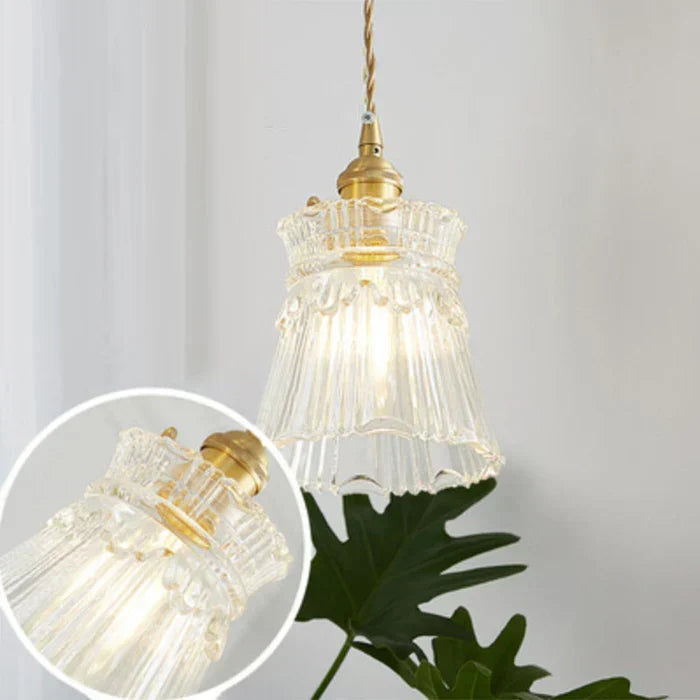 Modern dining room decor centered around a statement glass pendant lamp