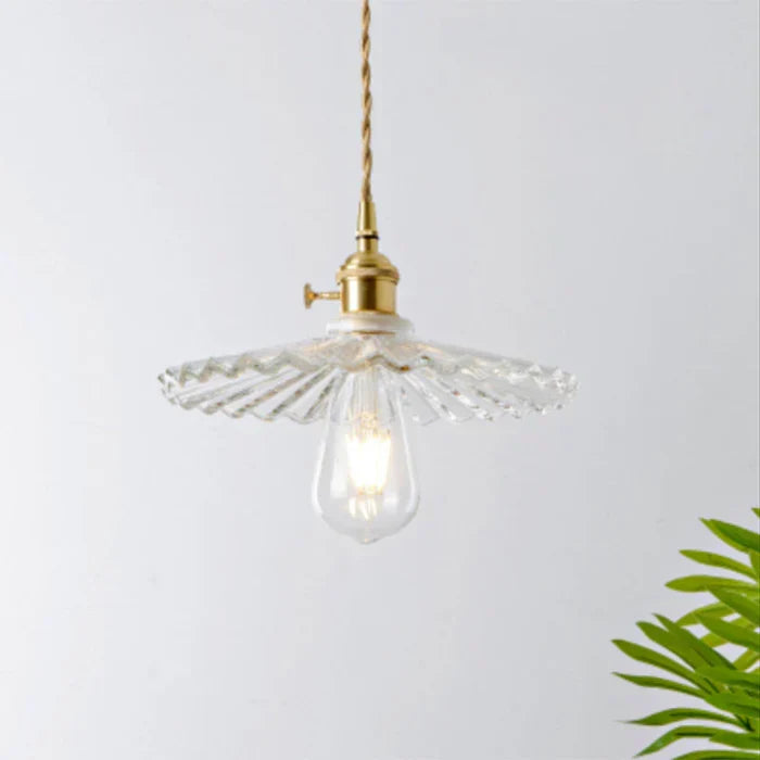 Modern glass pendant lamp viewed from a low angle highlighting its sleek shape