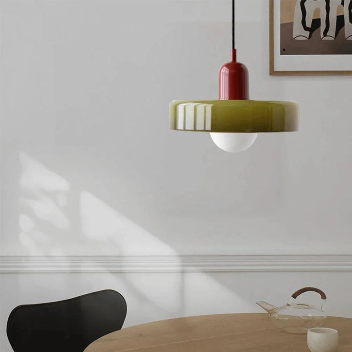Dining room lighting idea featuring a minimalist glass pendant