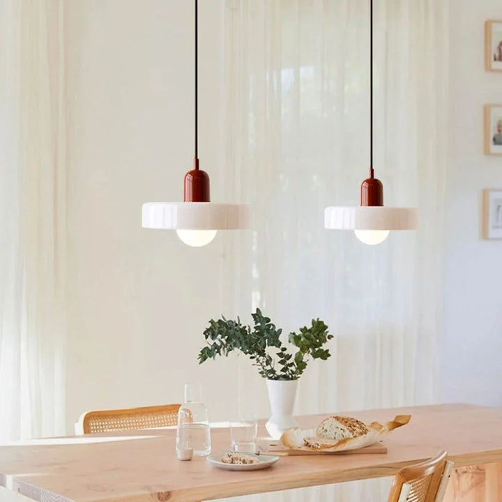 Minimalist ceiling pendant light hanging in a modern apartment