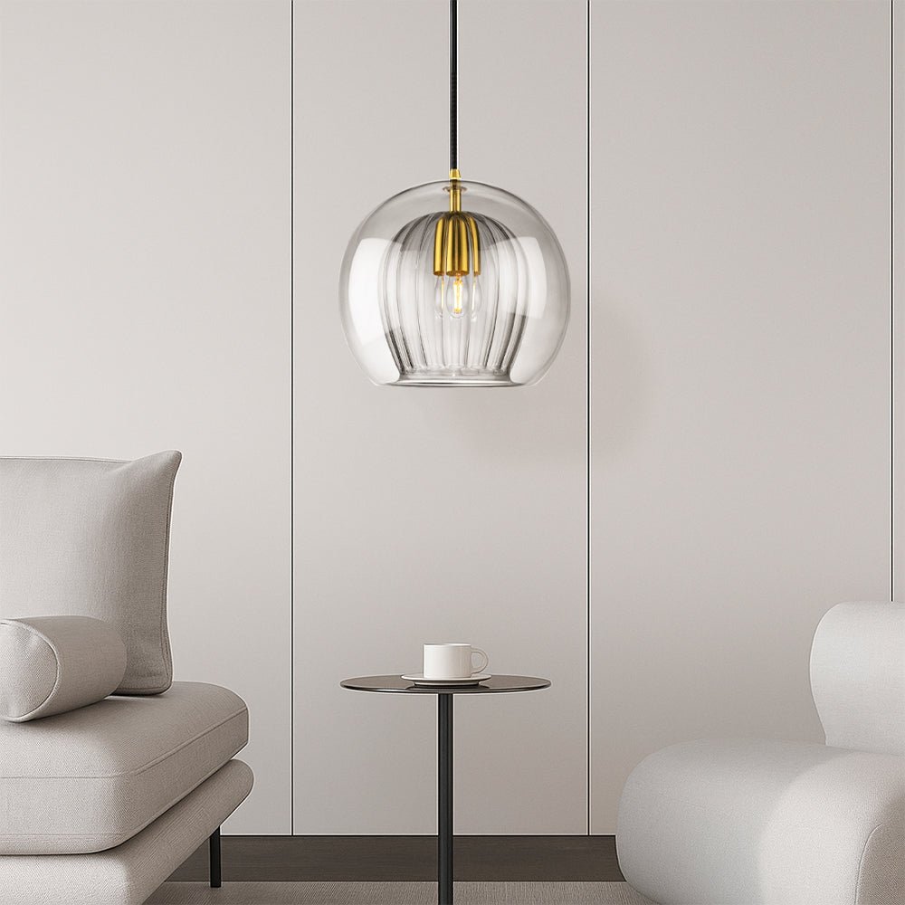 Modern glass lamp hanging over a sleek dining room table