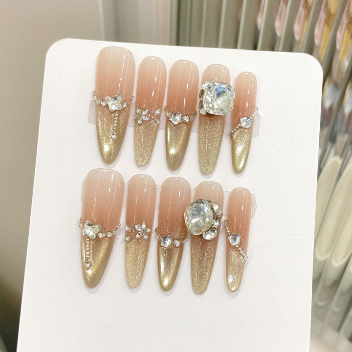 Full set of glittering press-on nail art pieces displayed on a white backing card