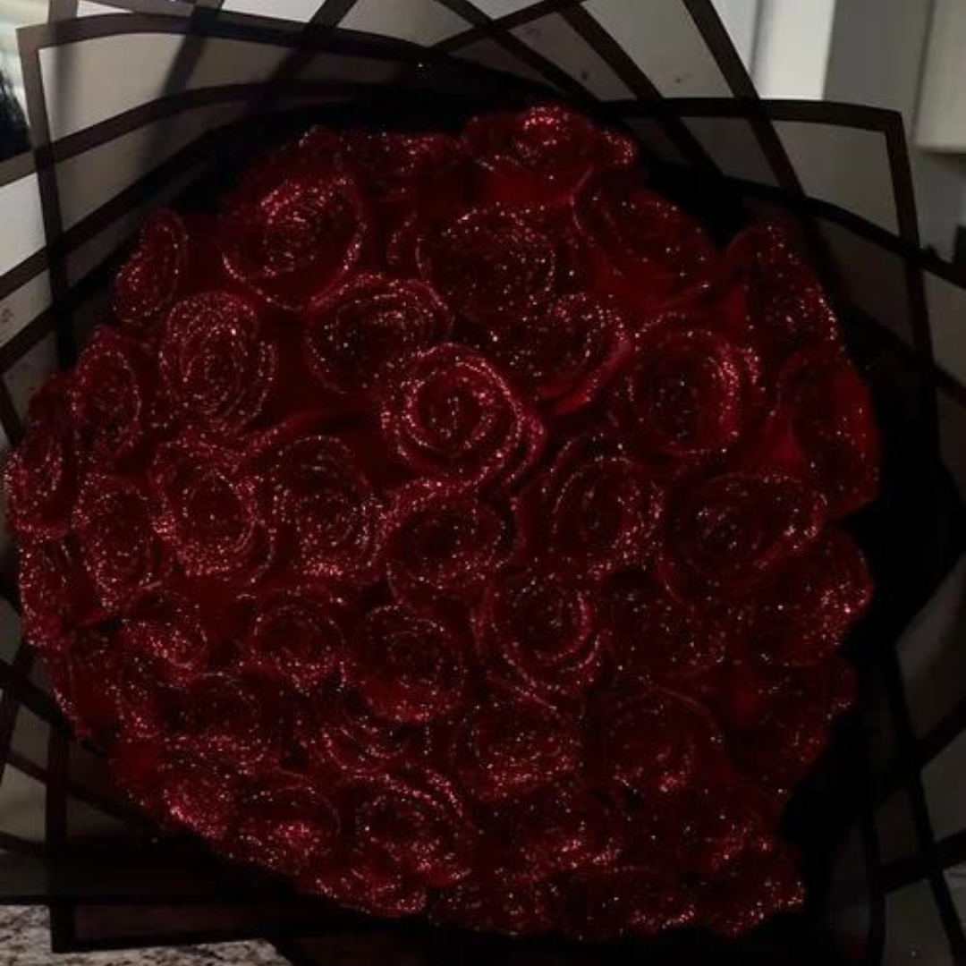 Close-up of radiant red glittering eternal rose heads in a bouquet arrangement