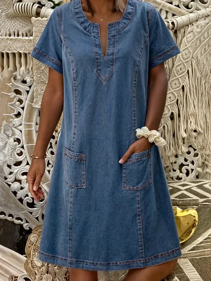 Model wearing blue casual V-neck dress with front pockets