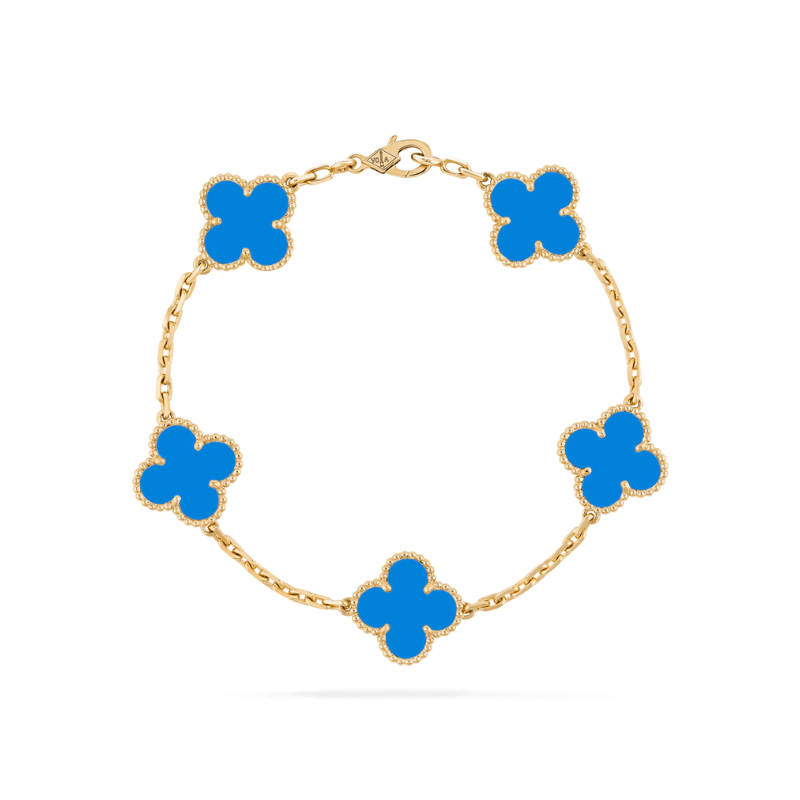 Statement gold bracelet with clover charms displayed as women jewelry