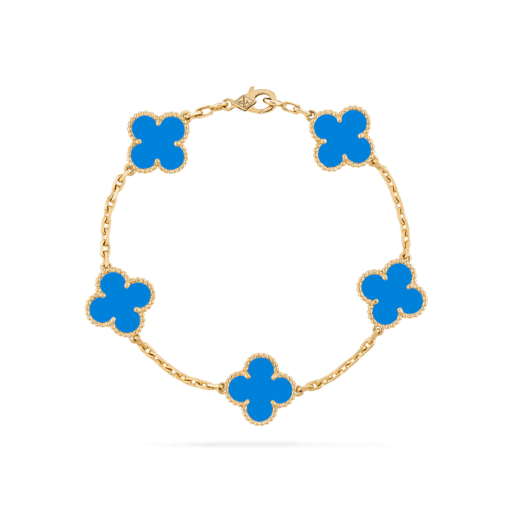 Statement gold bracelet with clover charms displayed as women jewelry