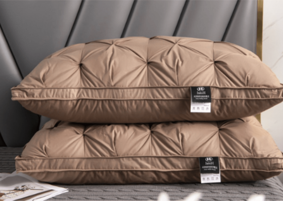 Two elegant brown goose down pillows arranged on a bed with a modern headboard