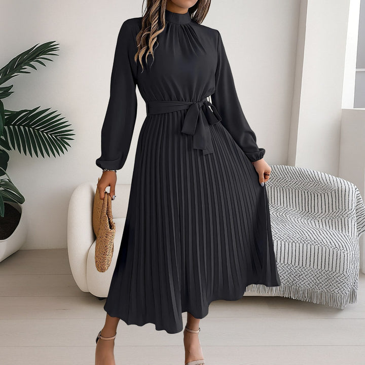 Back view of the flowing pleated midi dress with long sleeves