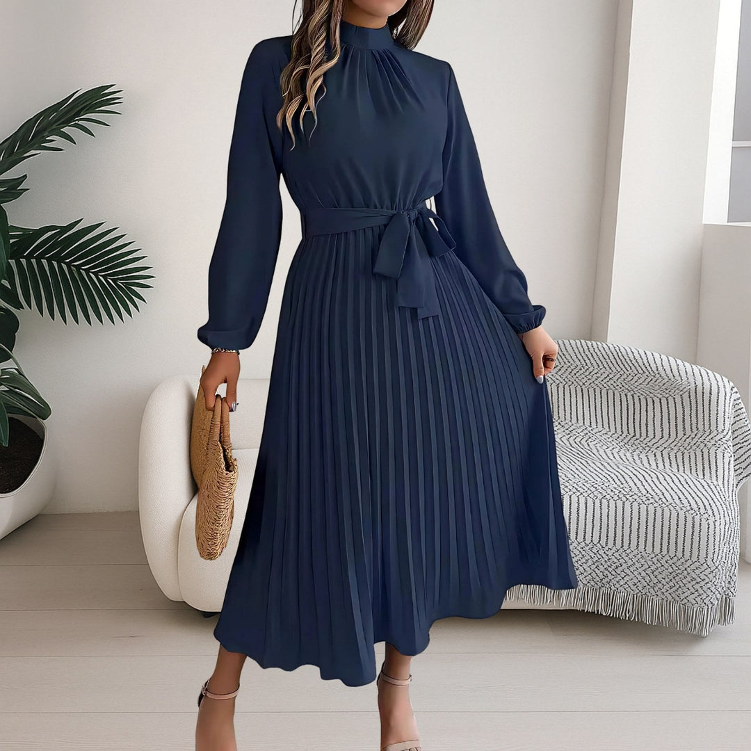 Full length view of the versatile pleated dress styled with a tie belt