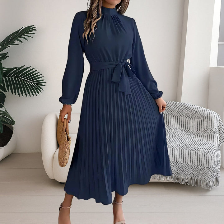 Full length view of the versatile pleated dress styled with a tie belt
