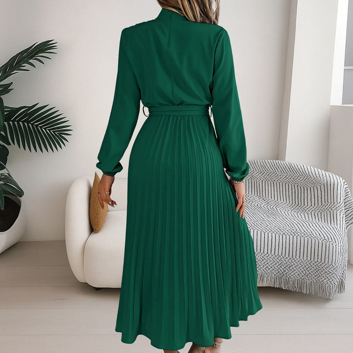 Back view showcasing the flowing pleated skirt and long sleeves of the midi dress