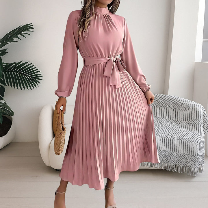 Detail shot of the fabric tie belt on the pleated midi dress