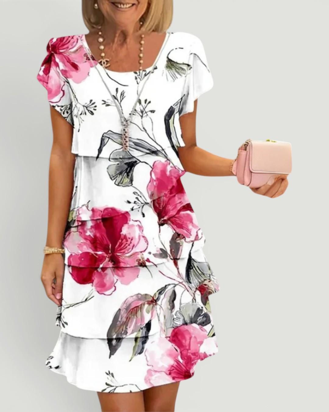 Woman wearing white floral tiered midi dress with flutter sleeves