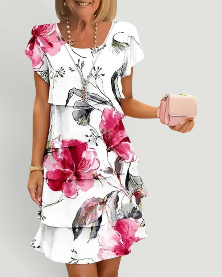 Woman wearing white floral tiered midi dress with flutter sleeves