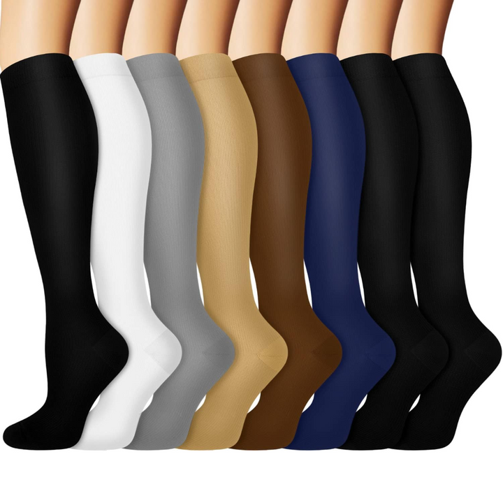 Assorted colors of knee-high copper compression socks laid out in a row