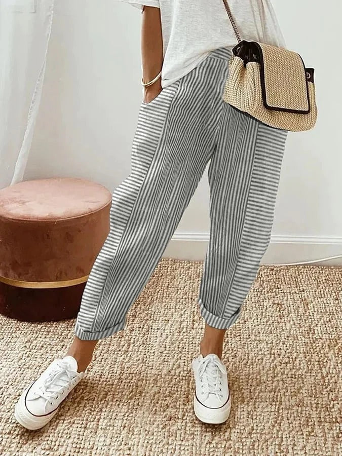 Full length view of women's striped relaxed trousers showing casual fit