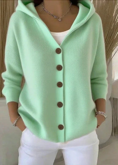 Side view of women's cozy knitwear sweater with attached hood