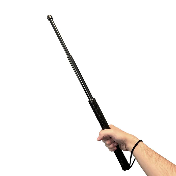 Hand holding an extended black self defense walking stick