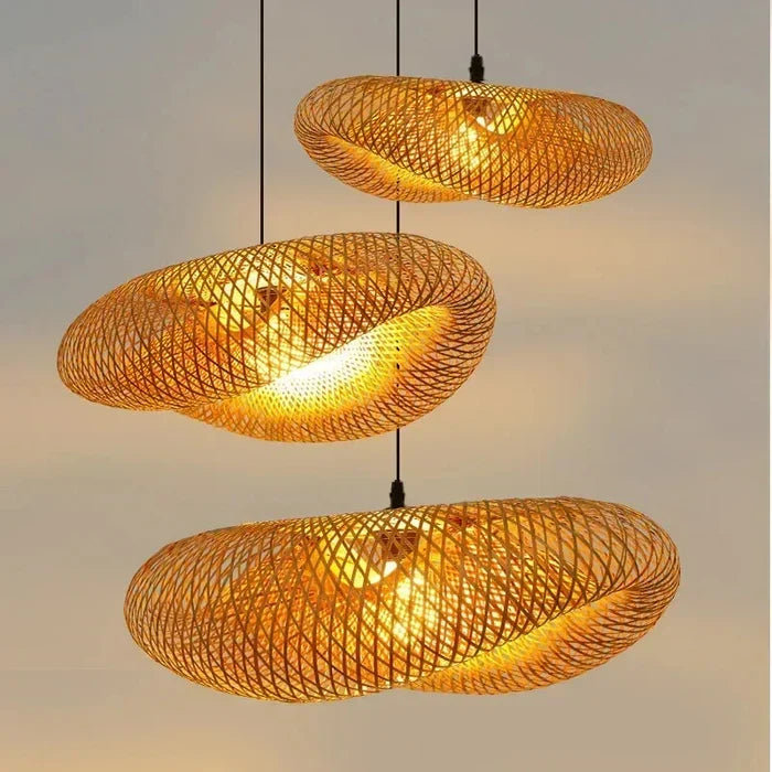 Three handwoven bamboo pendant lamps hanging vertically with warm illumination