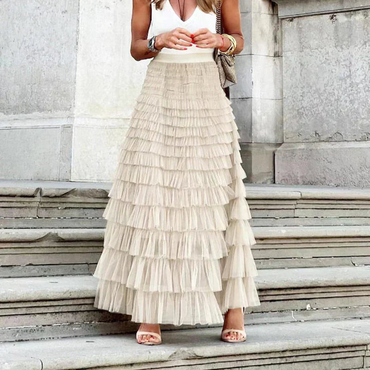 Close-up fabric detail of the stylish tiered maxi skirt showcasing light summer apparel texture.