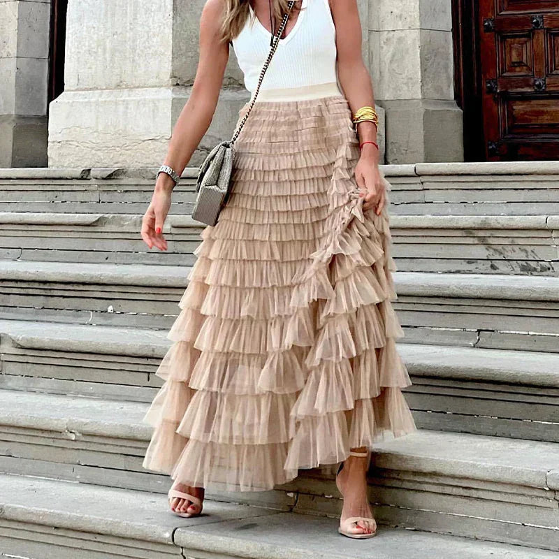 Close-up view of the ruffled layers and textured fabric on the khaki maxi skirt