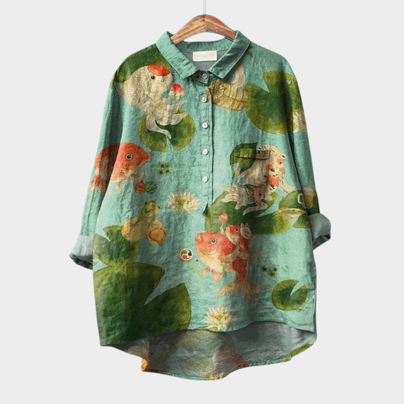 Detailed shot of fabric and cuffs on floral bird print blouse