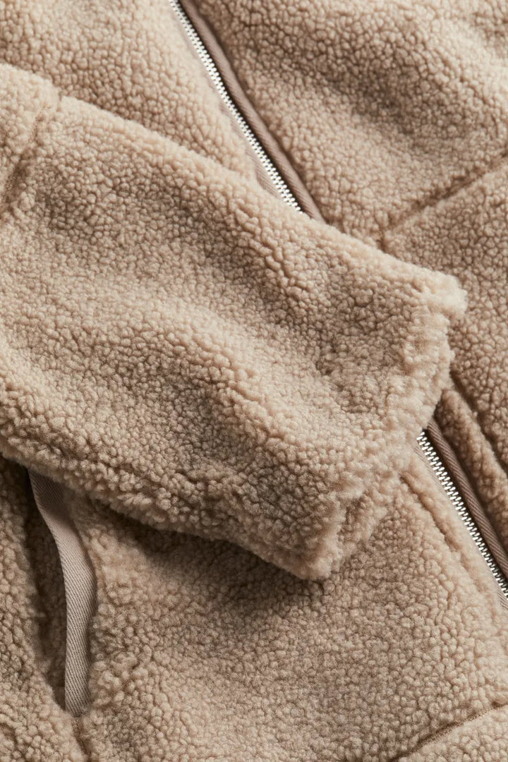 Side profile of casual beige zip-up fuzzy jacket for women