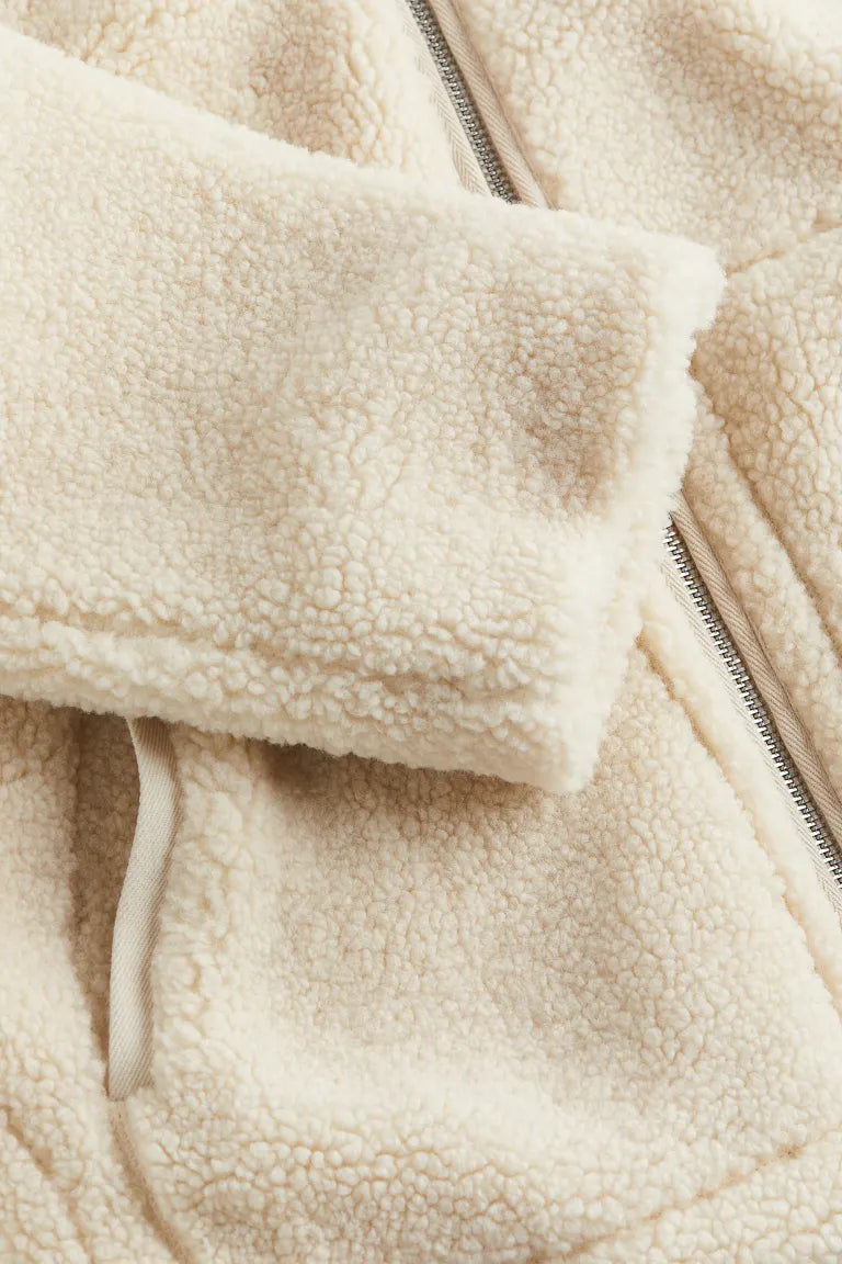 Close-up of soft fuzzy texture on women's winter teddy fleece outerwear