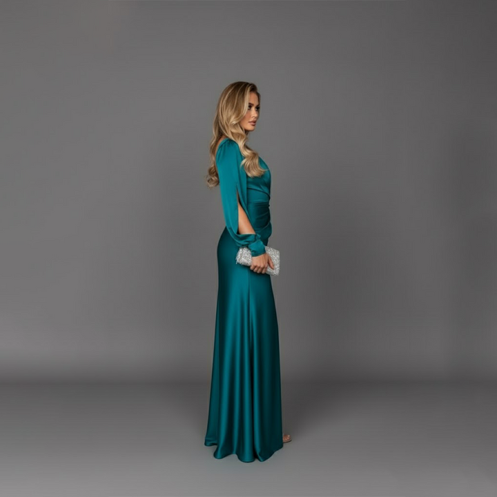 Side profile view of model in teal satin cocktail dress with single long sleeve