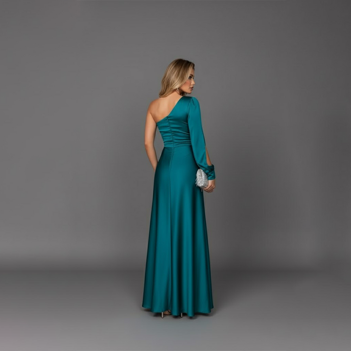 Back view of model showcasing the asymmetrical one-shoulder design of the teal gown