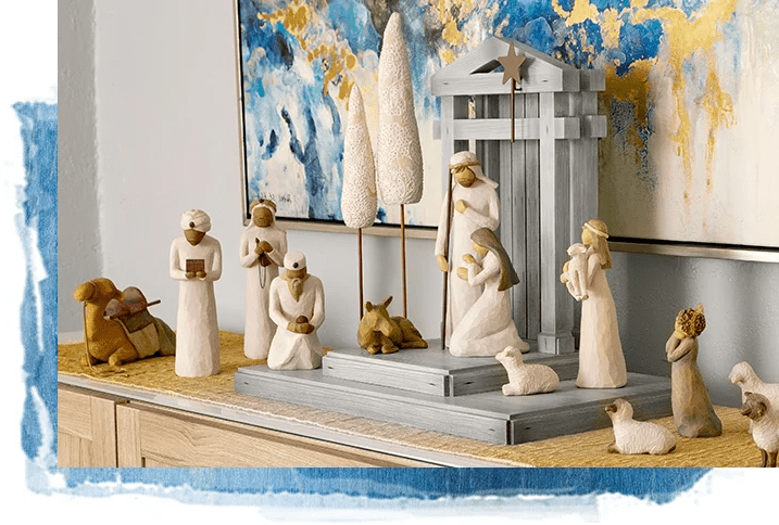 Close-up of wooden nativity figurines including baby Jesus in the manger