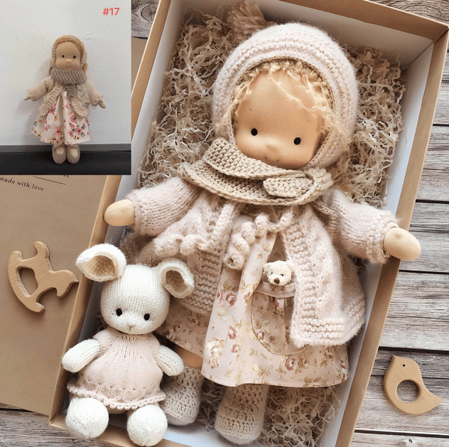 Close-up of handmade soft doll featuring embroidered face details and yarn hair
