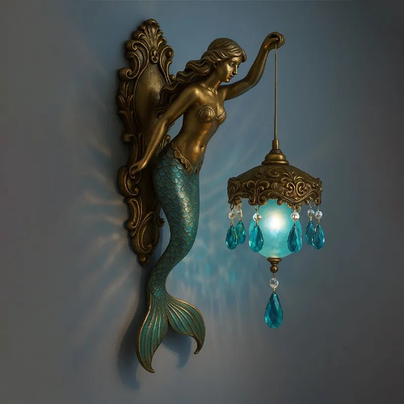 Handmade mermaid wall lamp with glowing blue crystals and warm LED light mounted on a grey wall
